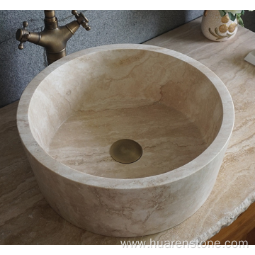 Round beige travertine sink